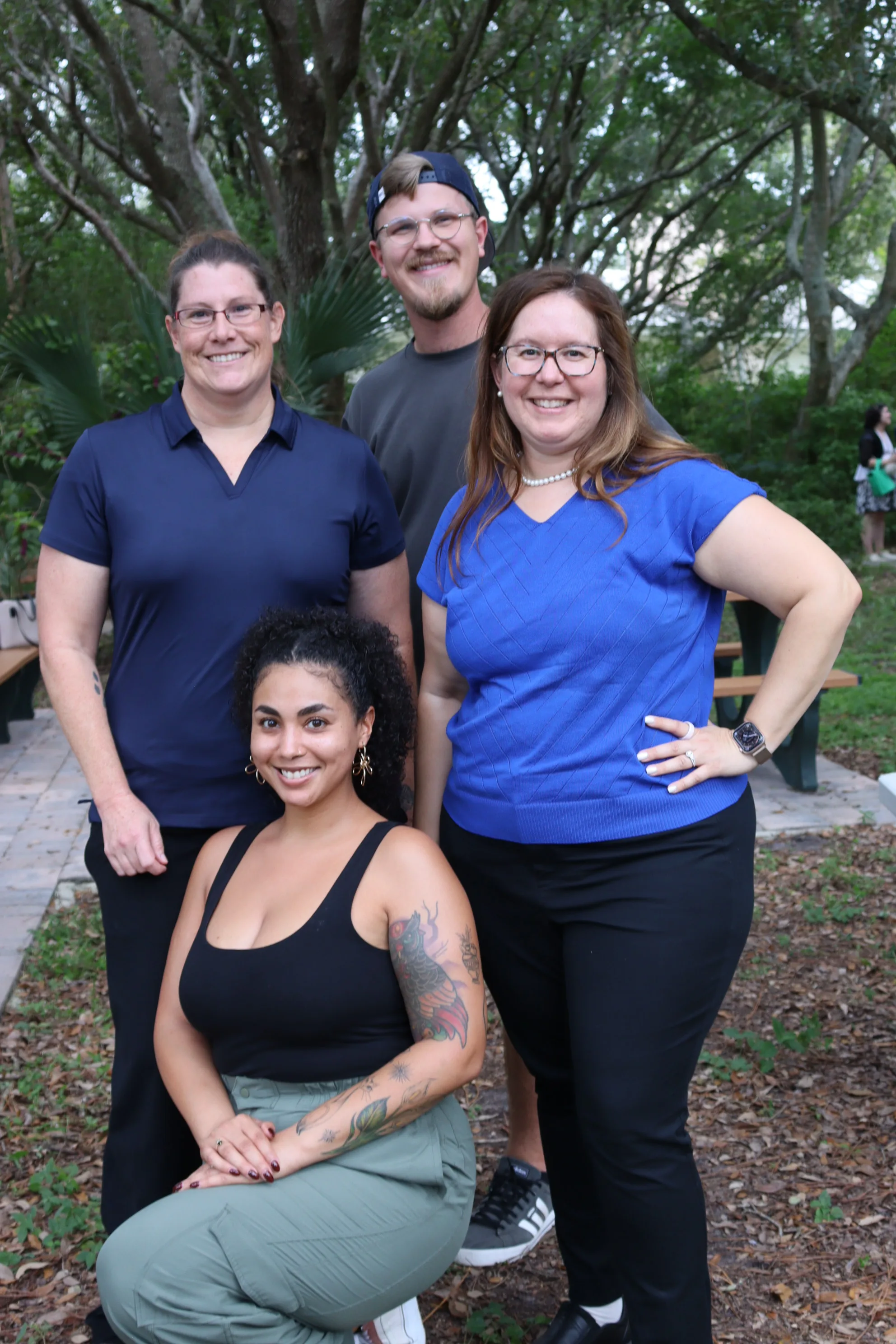 Areshika with the arboretum team posing outdoors under trees